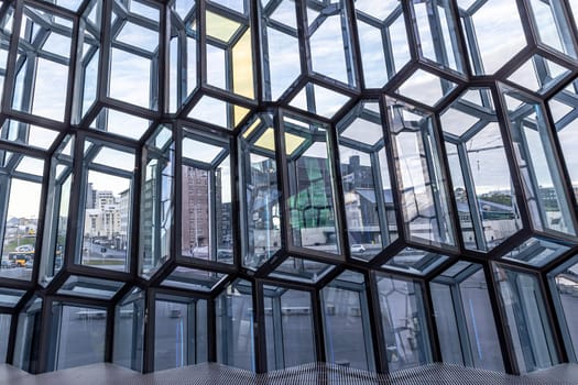 Harpa concert hall  Geometric glass facade reflecting  cityscape reykjavik, iceland,