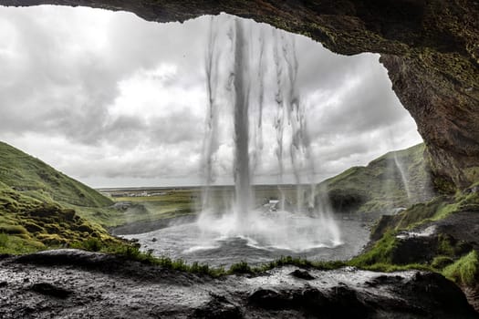 seljalandsfoss waterfall from behind the cascading water iceland