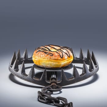 Delicious donut  metal  trap  bait, concept  unhealthy food dangerous addiction. 3d