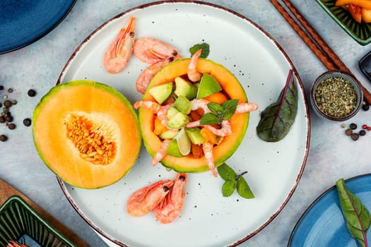 Asian salad of melon, shrimp and avocado. Summer light food.