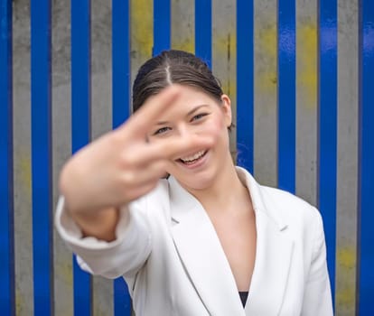 smiling young woman showing victory sign