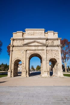 Famous Roman triumphal arch in Orange city, in the Vaucluse department in the Provence-Alpes-Côte d'Azur region. Vertical photography taken in France