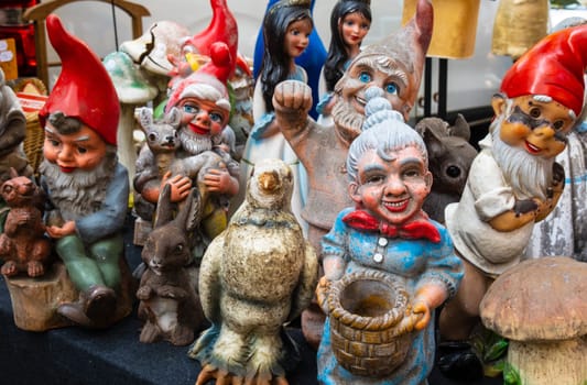 Lille, France - September 04 2022: Group of Second-hand garden gnomes and decoration figurines