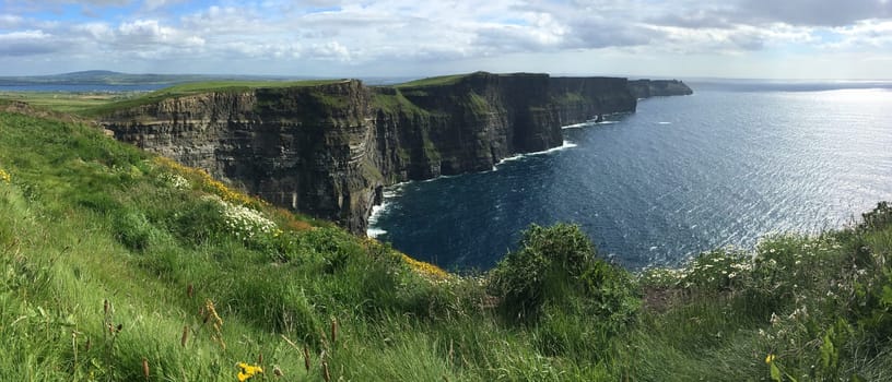 Panoramic view of the Cliffs of Moher - located at the southwestern edge of the Burren region in County Clare, Ireland. They rise 120m (390ft) above the Atlantic Ocean at Hag's Head and reach their maximum height of 214m (702ft) here just north of O'Brien's Tower.
