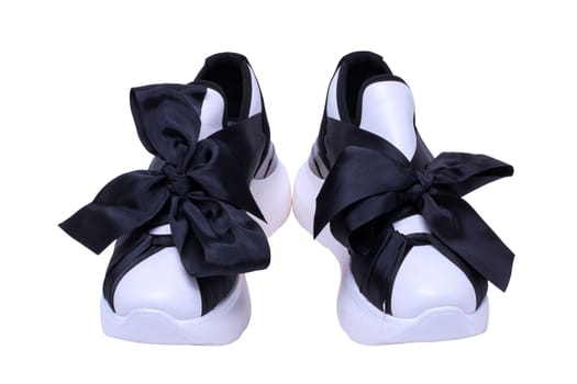 White sneaker isolated. Close-up of a pair black white elegant stylish female leather high-heeled sport shoes isolated. Clipping path. Womens shoe fashion. Modern design footwear for workout.