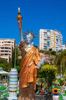 TORREMOLINOS, SPAIN - May 21, 2019. The replica of the Statue of Liberty and the Leaning Tower of Pisa in a hotel leisure centre on the Costa del Sol.