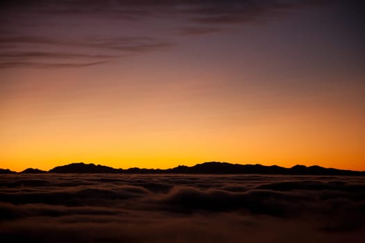 Spectacular sunset over a sea of clouds. Beautiful landscape