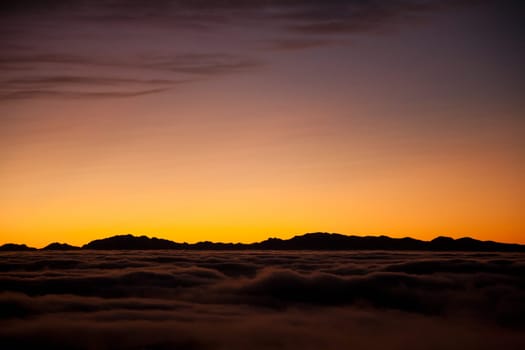 Spectacular sunset over a sea of clouds. Beautiful landscape