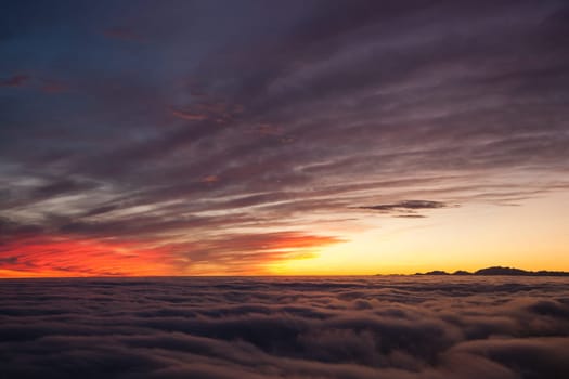 Spectacular sunset over a sea of clouds. Beautiful landscape