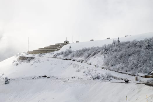Mountain winter landscape. Mount Grappa war memorial building view. Italian landmark