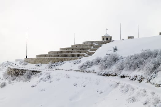 Mountain winter landscape. Mount Grappa war memorial building view. Italian landmark