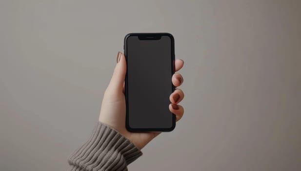 Woman's Hand Holding a Smartphone with a Blank Screen
