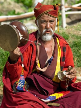 A Bhutanese man with prayer drum at Paro Monastery in the Kingdom of Bhutan.