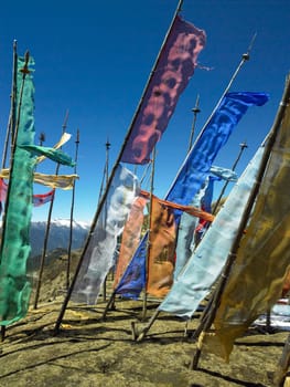 Buddhist prayer flags on a hillside high in the Himalayas in the Kingdom of Bhutan.