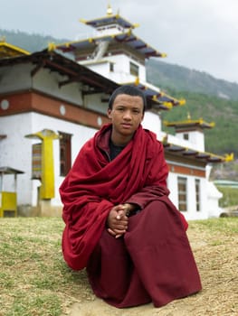 A young Bhutanese monk at Thimphu Dzong in the Kingdom of Bhutan.