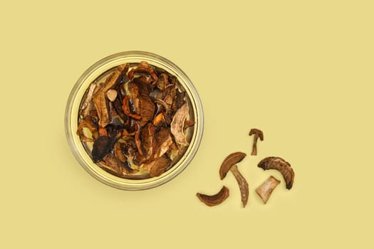 Dry forest mushrooms soaking in water, top view