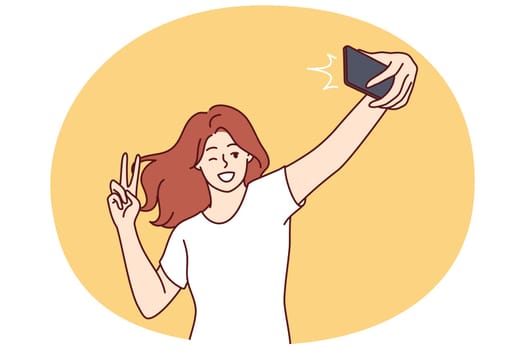 Woman laughs taking selfie and showing peace sign to post photo on social network or dating site. Positive girl blogger doing gesture with fingers recording selfie video for subscribers