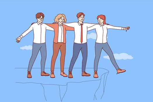 Well-coordinated teamwork business people allows to avoid risk and save colleagues from falling off cliff. Teamwork of men and women in business attire demonstrating successful synergy and unity