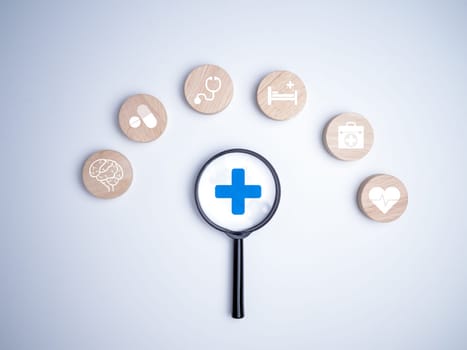 A magnifying glass focus on the plus sign and healthcare medical icon on white background, Health insurance concept, Health and access to welfare health concept, Welfare service concept, Healthy and lifestyle.