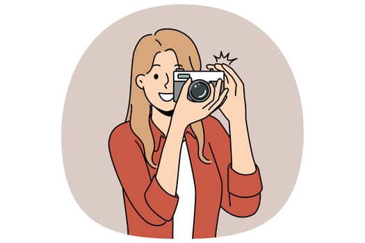 Woman with camera with smile takes photo for publication in newspaper or on pages of personal internet blog. Young happy girl uses camera to capture picturesque locations while traveling