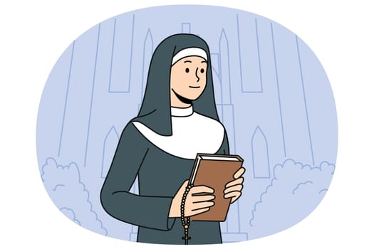 Woman nun with bible stands near church calling to visit christian shrines and study gospel or religious prayers. Catholic nun in white and black cassock holds cross for traditional orthodox rituals.