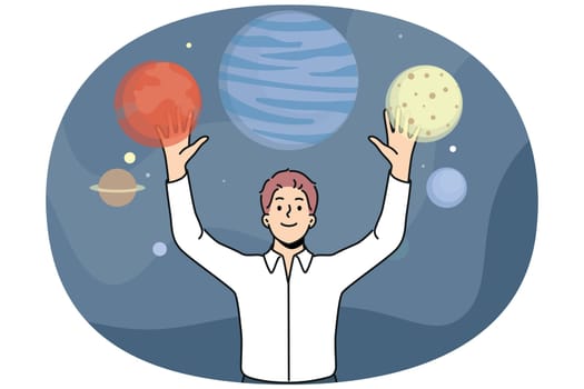 Man stands among planets of space and enjoys virtual reality technology that allows to travel around galaxy. Guy who loves space explores universe thanks to digital planetarium with VR
