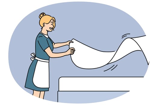 Woman maid makes bed with sheets, preparing hotel room for arrival of new guests. Maid with smile doing job enjoying career in hospitality industry and becoming professional in horeca industry
