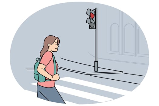 Woman pedestrian crosses road at red traffic light, putting own life and health of car drivers at risk. Girl demonstrates lack of civic consciousness by breaking rules when crossing road