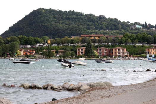 Boats in the water,a storm is gathering in front of the small picturesque bay of Manerba del Garada on Lake Garda  Travel Photography - Lake Garda / Lago di Garda / Italy /Italy / Italia
