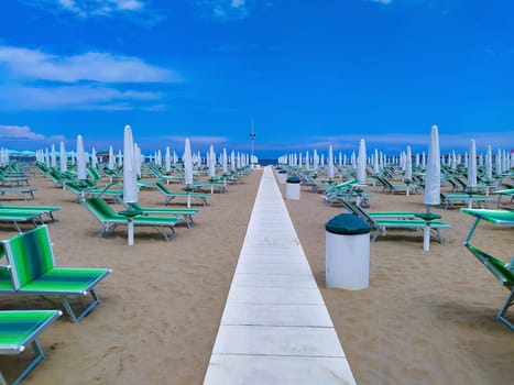 Summer. The sunbeds and parasols on the empty beach