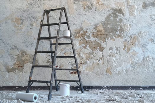 Home renovation - old flat during renovation. Aluminium ladder in a room under construction works. Repair process in an empty bright room.AI generated