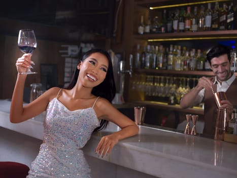 Woman is holding a glass of red wine. Bar, Restaurant, hospitality and beverage, Night club concept.