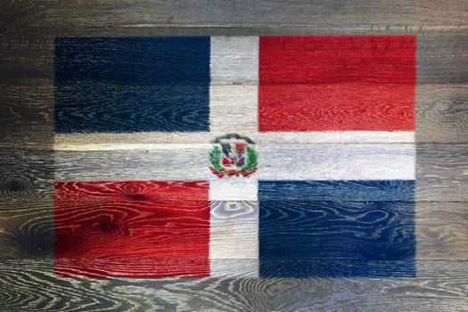 A Dominican republic flag on rustic old wood surface background red white blue