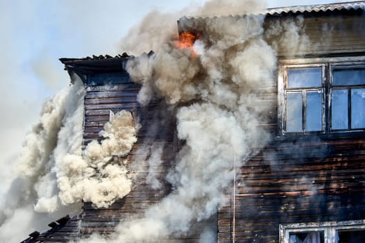 fire on the roof of a wooden house. High quality photo