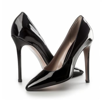 Black patent leather high heels on a white background. Elegant stiletto shoes