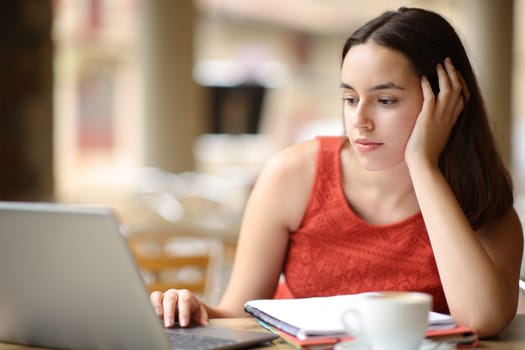 Student e-learning using computer sitting in a coffee shop
