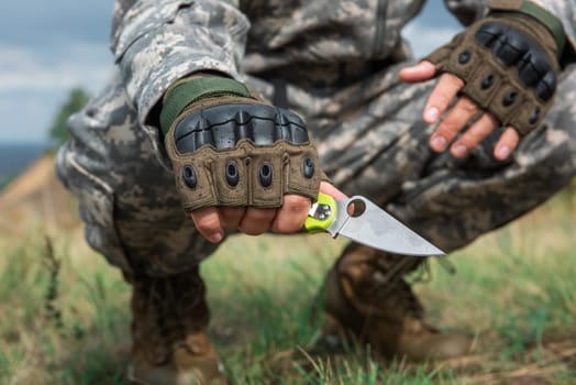 A man with a knife in the forest. Travel or military concept