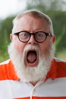 Portrait from emotional screaming senior man with beard