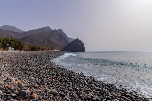 Gran Canaria, Spain: March 17, 2024: People at the black sand beach paradise in La Aldea, Gran Canaria, Canary islands, Spain