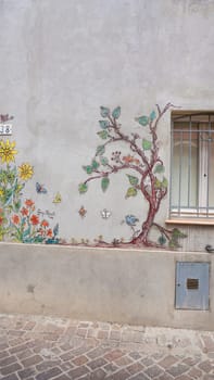 Rimini, Italy - June 25, 2024: Mural on wall at Borgo San Giuliano typical street with low and colorful houses at Rimini, Italy