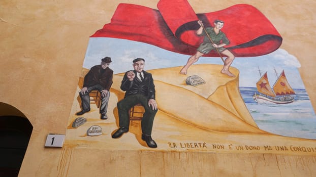 Rimini, Italy - June 25, 2024: Mural on wall at Borgo San Giuliano typical street with low and colorful houses at Rimini, Italy