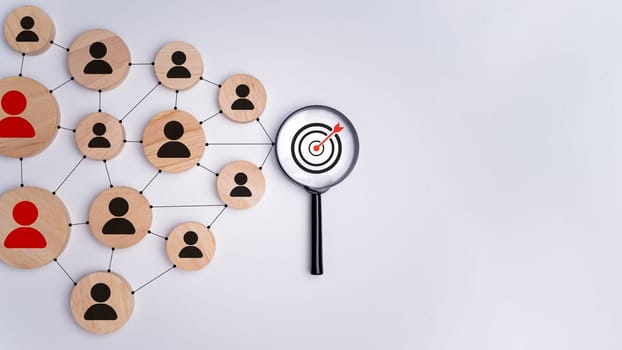 Wooden block with target icon linked with human icons for customer focus group, Customer relationship management concept, CRM, Customer relationship management and targeted marketing strategies.
