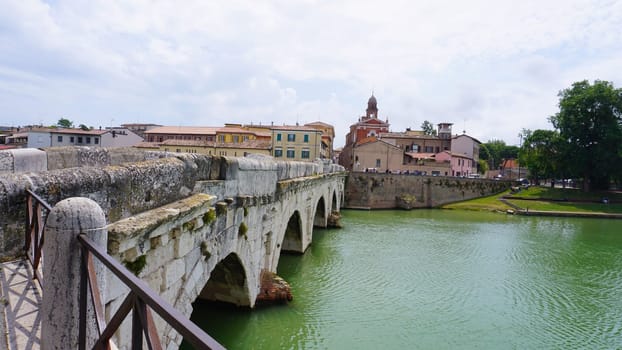 Historical roman Tiberius Bridge over Marecchia river in Rimini at Italy
