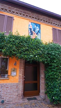 Rimini, Italy - June 25, 2024: Mural on wall at Borgo San Giuliano typical street with low and colorful houses at Rimini, Italy