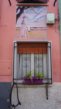 Rimini, Italy - June 25, 2024: Mural on wall at Borgo San Giuliano typical street with low and colorful houses at Rimini, Italy