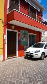Rimini, Italy - June 25, 2024: Mural on wall at Borgo San Giuliano typical street with low and colorful houses at Rimini, Italy