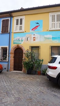 Rimini, Italy - June 25, 2024: Mural on wall at Borgo San Giuliano typical street with low and colorful houses at Rimini, Italy