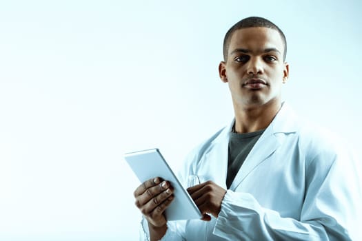 Young data scientist specializing in deep learning and LLM analysis, holding a digital tablet. Dressed in a white lab coat, his serious expression reflects his passion for data science, big data, and