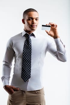 Man dressed in a white shirt and tie, holding a business card. His confident demeanor and professional look indicate he is prepared for networking and business meetings
