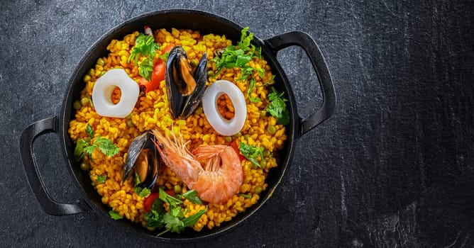 Seafood paella served in a cast iron pan.